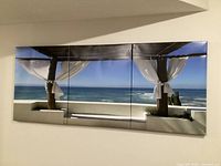 Full view of three-panel canvas wall art mounted on wall