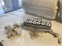 Full set on bed: heater with 12 rollers, clips, pins, power cord
