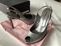 Overall view of both shoes with box visible