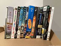 Front view of standing DVDs showing Age of Empires III, Breaking Bad seasons, Spaceballs, Seinfeld, JFK, etc.