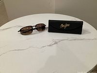 Sunglasses with hard case on white table