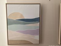 First framed abstract landscape canvas art piece showing color bands and sun motif