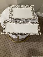 Both rectangular trays on table showing size difference and geometric silver rims