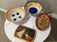 Group view of three bowls and cheese tray on table