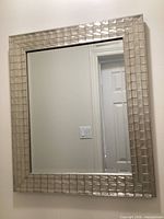 Large silver mirror on wall showing full frame