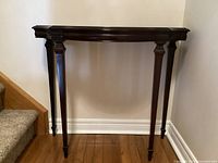 Front view of demilune hall table against wall