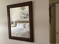 Full view of vertical wall mirror hung on wall