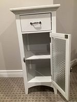 Cabinet door open showing interior shelf and drawer