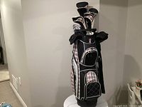 Full view of golf bag with clubs and headcovers