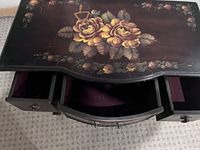 Top view with drawers open showing floral painting and felt lining