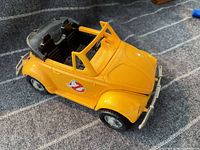 Left front three-quarter view showing yellow Ghostbusters VW Beetle convertible