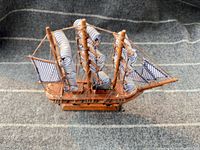 Port side view showing overall ship, sails and stand