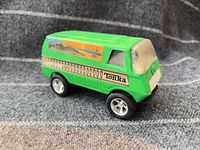 Left front quarter view of green Tonka van showing decal, wheels, and general condition