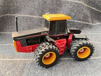 Left side view of Versatile 836 tractor showing paint wear and wheel detail