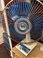 Front view showing blue blades, wire grill, control base