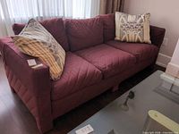 Front view showing three seat cushions and two throw pillows