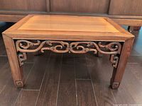 Full view of low Chinese kang table showing carved apron and overall design