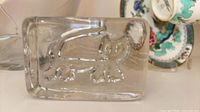 Front view showing full cat relief design in clear glass block