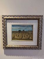 Frontal view of framed painting showing artwork, mat and ornate frame