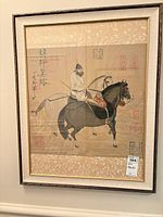 Full view of the framed Japanese equestrian scroll painting showing overall composition and frame