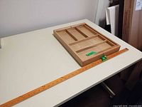 Wooden desk tray on table with yardstick for scale