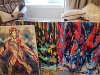 Front view of three acrylic paintings leaning together