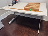 Full view of table top and metal T-base legs