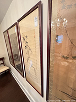 Three of the framed paintings on wall showing size and frames