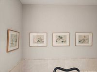 All four framed prints mounted on wall