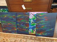 Front view of four abstract canvases