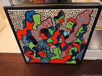 Front view of framed abstract painting