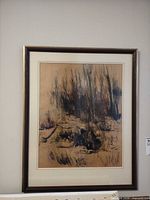 Framed mixed media artwork hung on wall