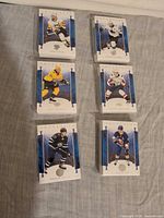 Front view showing six stacks of sleeved Artifacts hockey cards