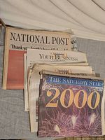 Stack showing National Post, Your Business supplements and The Saturday Star 2000 cover