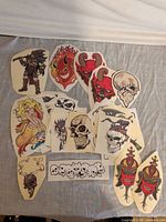 Group shot of assorted vinyl decals laid out on fabric showing variety of designs and sizes