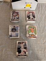 Front angle showing multiple stacks of baseball cards and box