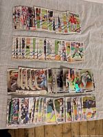 Overhead view of four spread stacks of Bowman and Topps Chrome baseball cards
