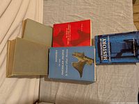 Five books arranged on surface showing titles and formats