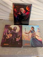 Front view of all three Magic: The Gathering binders showing distinct cover artwork
