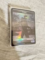 Stack of sleeved foil Zombie token card on top