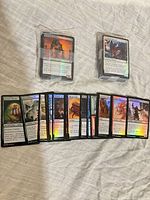Two shrink-wrapped stacks plus spread of foil MTG cards