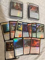 Two sleeved stacks of foil cards and twelve displayed examples