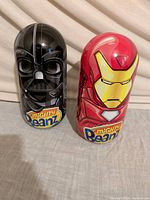Both Darth Vader and Iron Man tin canisters side by side