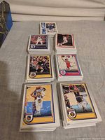 Eight stacks of Panini Hoops basketball cards displayed on table