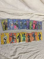 All 15 holographic Fortnite cards laid out in two rows, sleeves and top-loaders visible