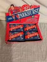 Full view of open display box with four visible sealed packs