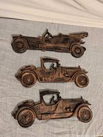 All three vintage car plaques displayed front view
