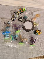 Group of Skylanders figures, portal and crystal traps spread on surface