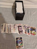 Cards spread out with one card showcased and storage box visible