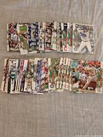 Front view showing two rows of Topps Holiday Snowflake baseball cards spread on fabric